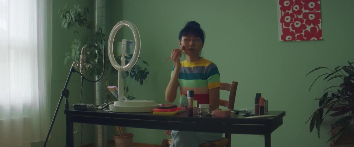 A woman doing makeup with her smartphone