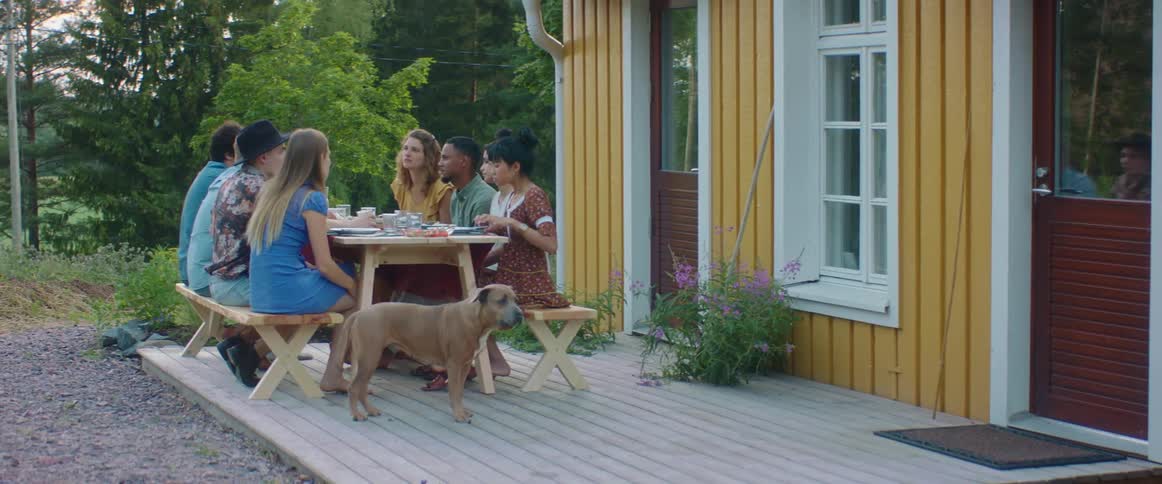 The table outside is full of people eating