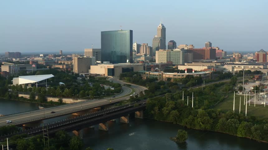 An aerial view of skyscrapers and a large city bridge in the daytime