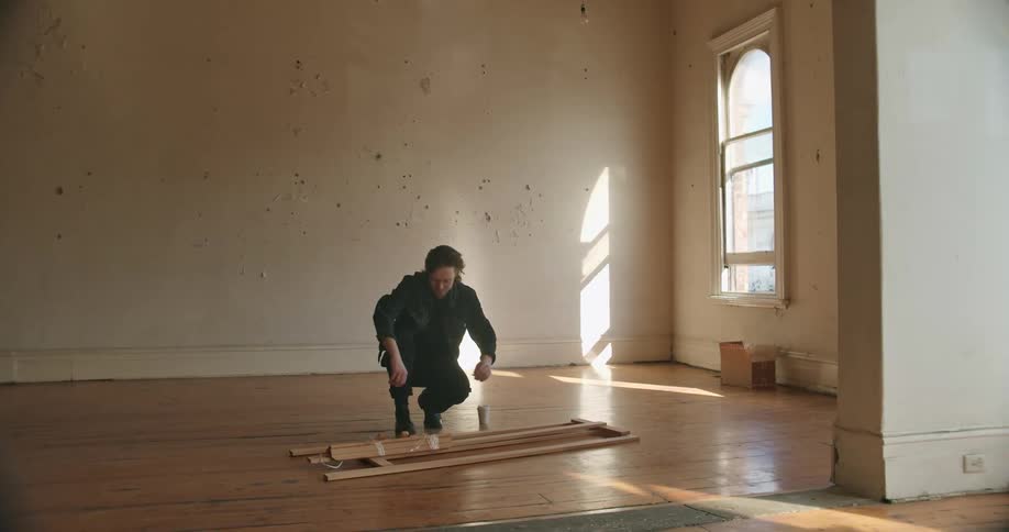 A man setting down an easel