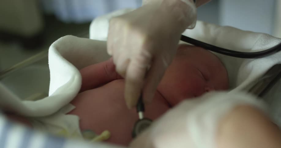 A view of a doctor checking a babys heart