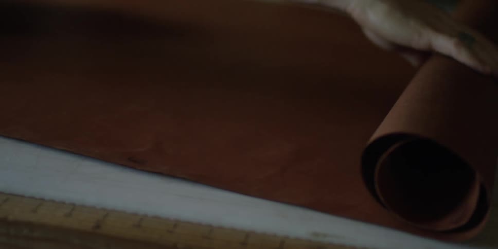Paper is being rolled by a person