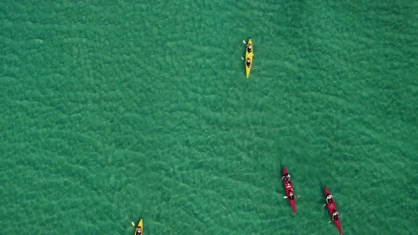 An aerial view of canoes in the water