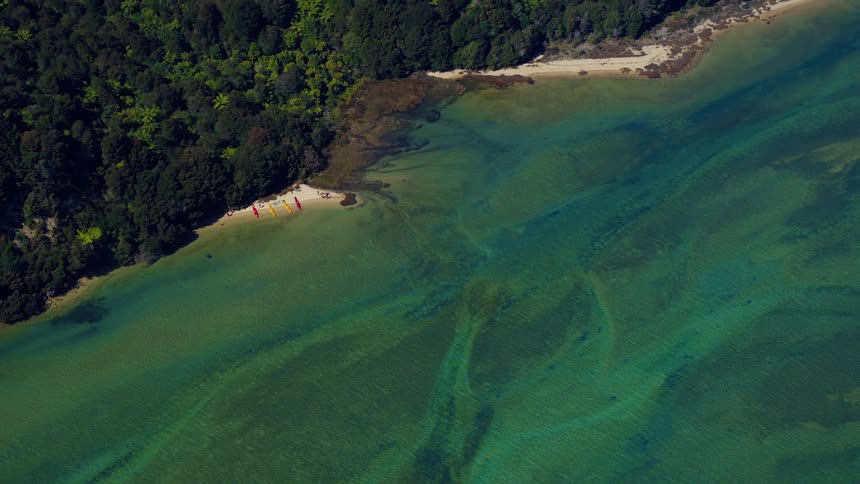 An aerial view of some boats on a coast