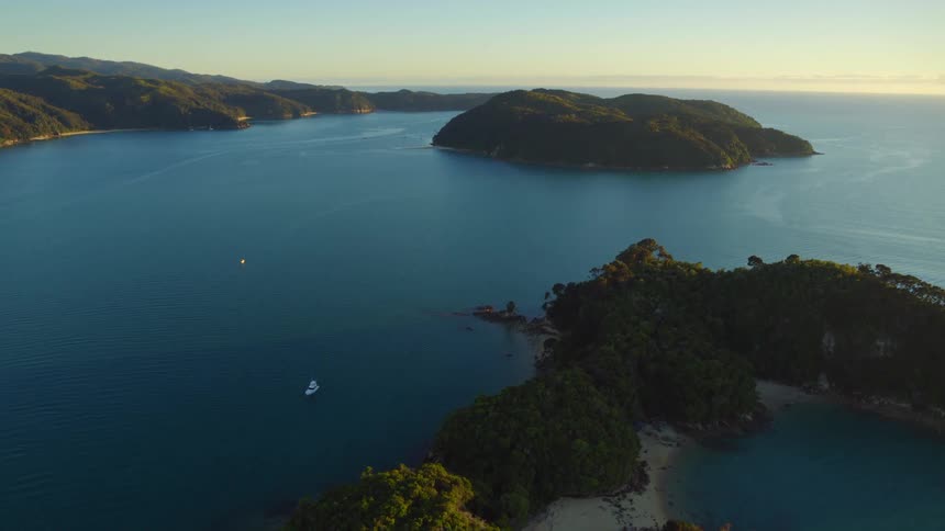 Boat moves along ocean between islands and the shore