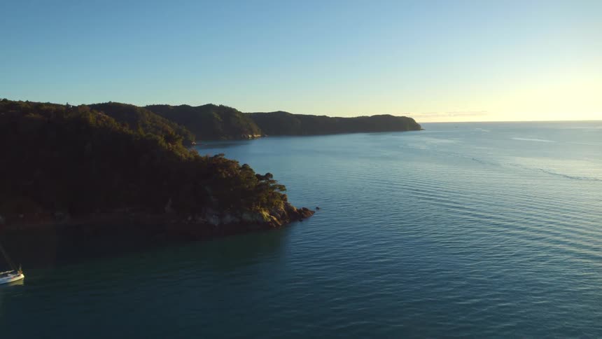 Coastline with buoys floating in the water under a clear sky