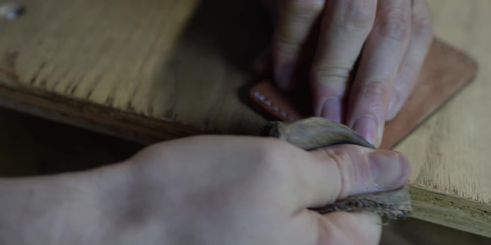 A piece of leather is being polished