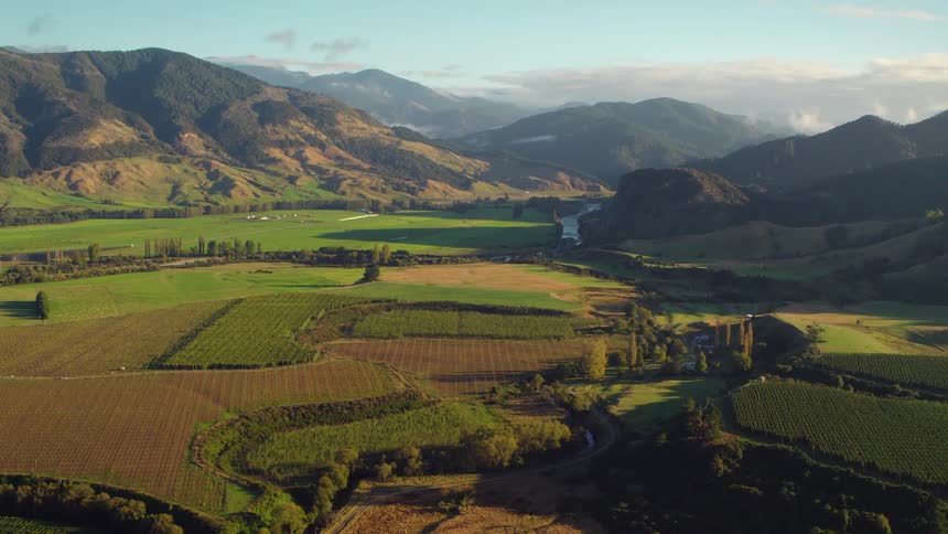 The large farm is before the mountain range