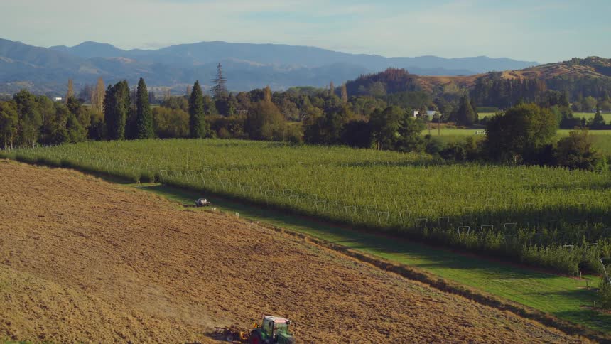 A farm vehicle is working the fields