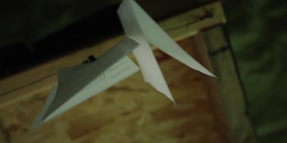 View of papers clipped to the bottom of a cabinet