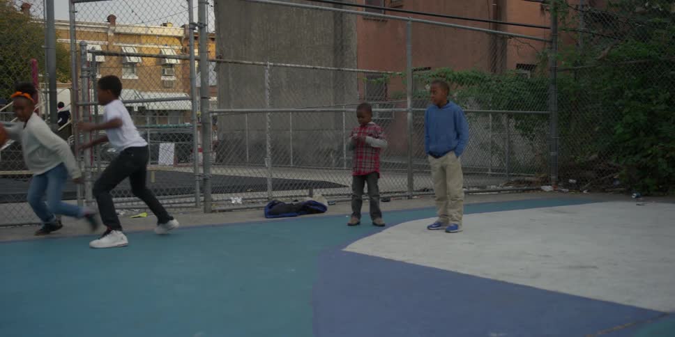 A group of kids playing basketball