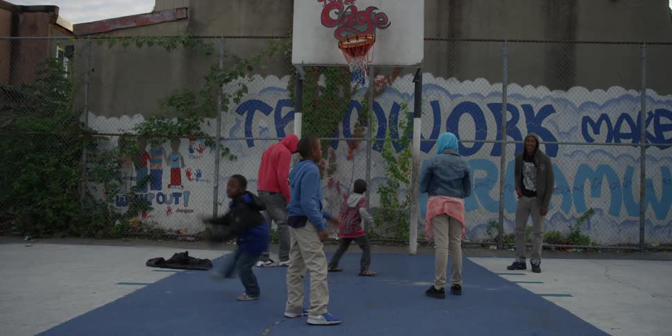A group of children are playing basketball