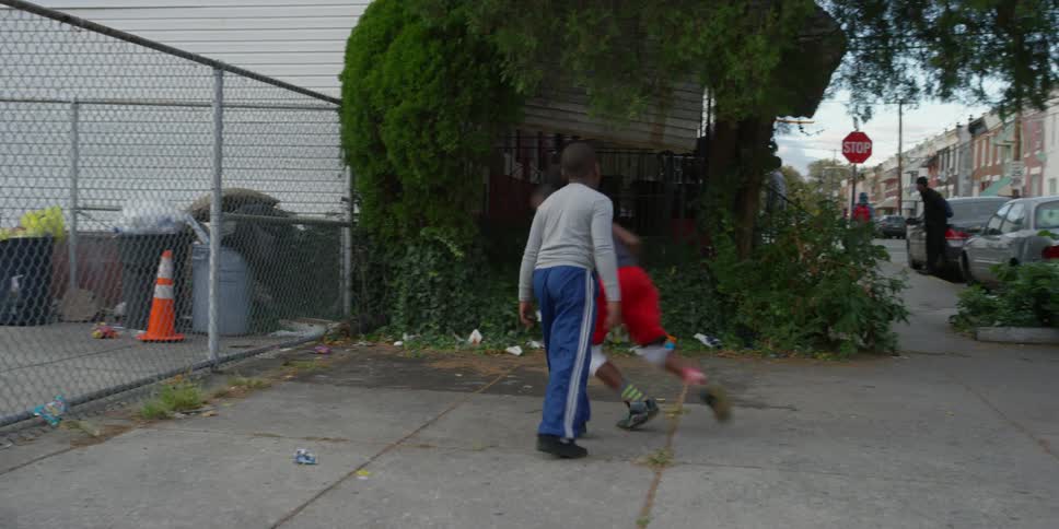 Kids playing basketball on an urban lot