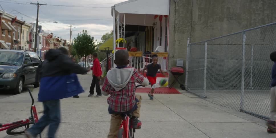 A group of children are playing on a sidewalk