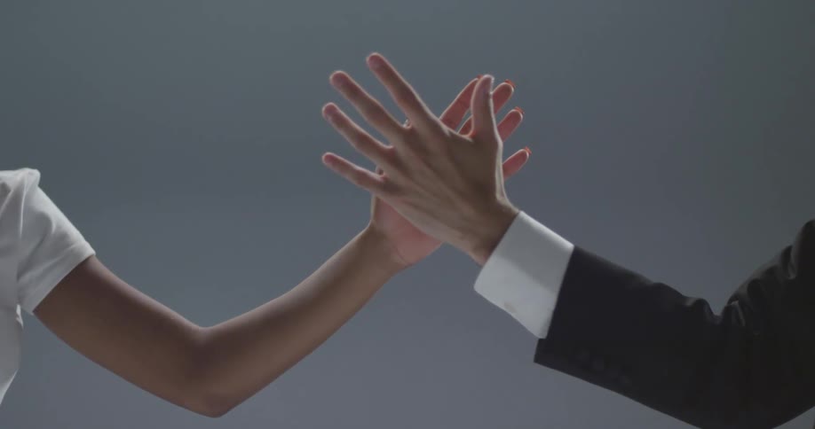Two dancers let go each others hands then the male reaches toward the woman