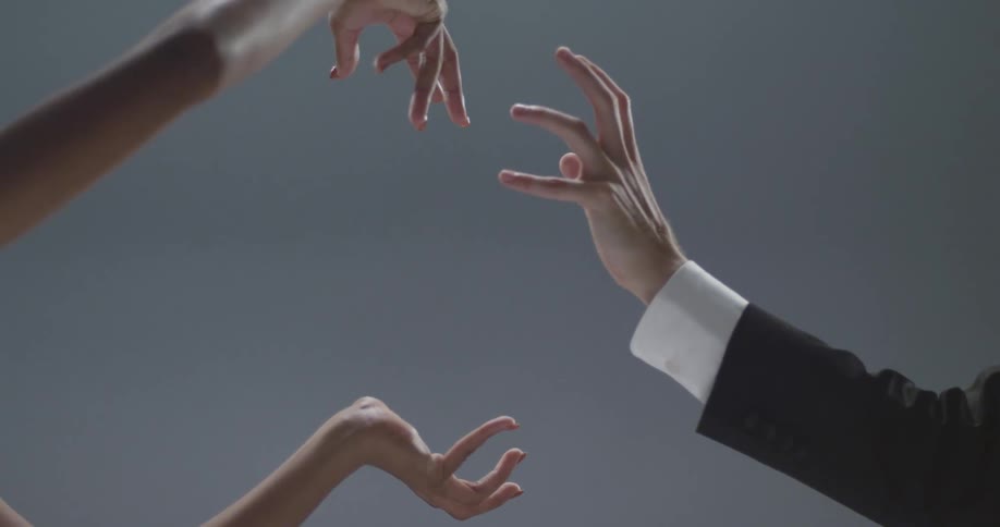 The arms and hands of male and female dancers move in an expressive and romantic way