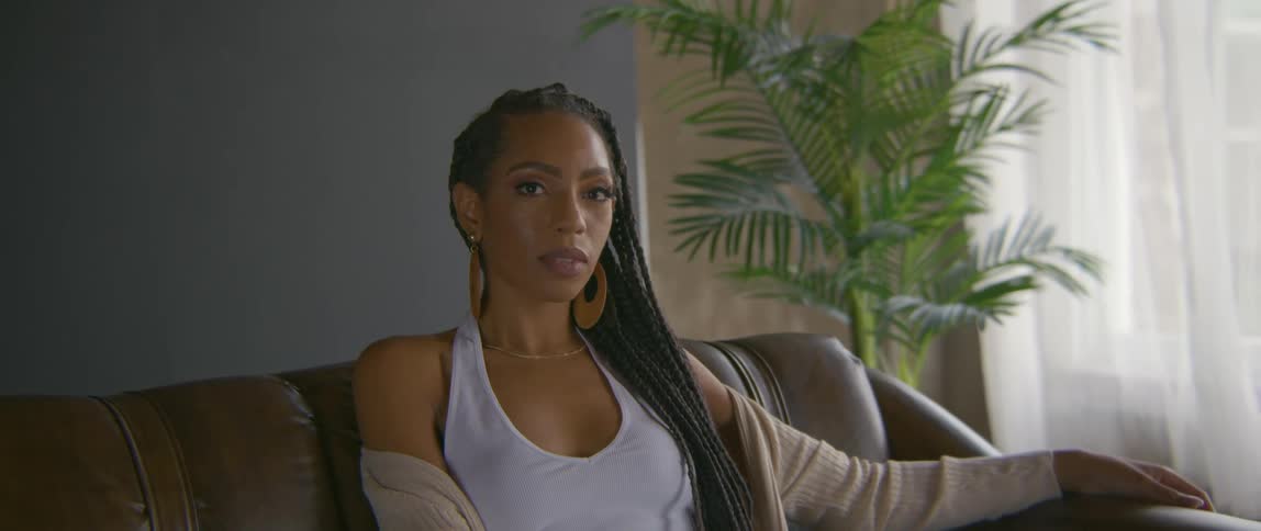 A portrait of a woman sitting on a couch