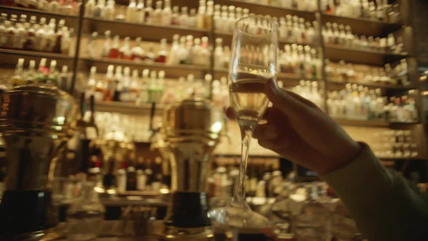 man and women having champaign at bar in celebration