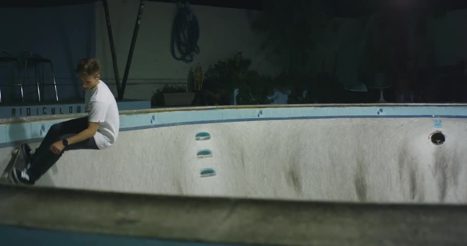 A young person is riding a skateboard inside a rink
