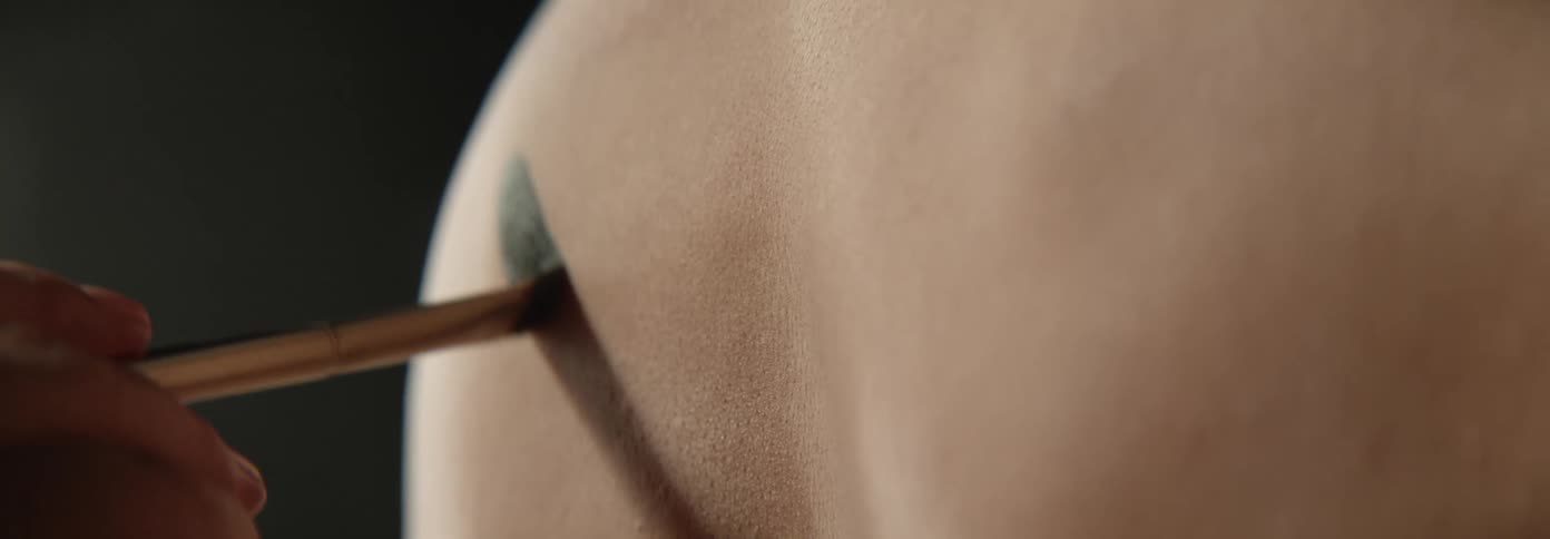 Paint is applied to the persons back