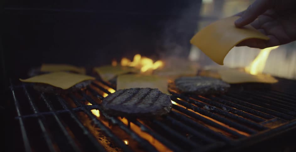 Person cooking burgers