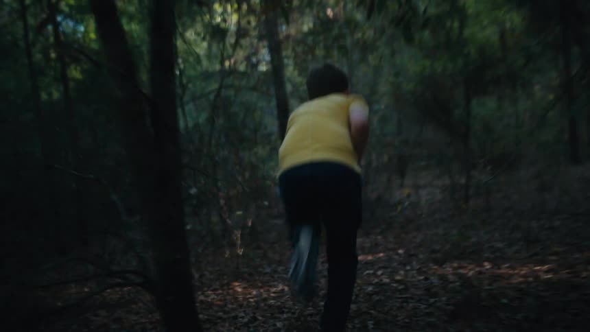 A child runs through the forest