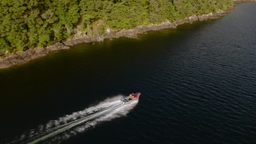An aerial view of a boat traveling down a river