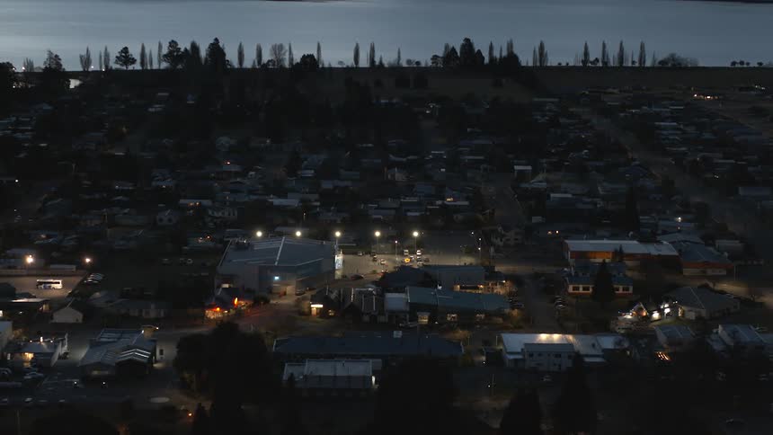 The town is dark at sunset