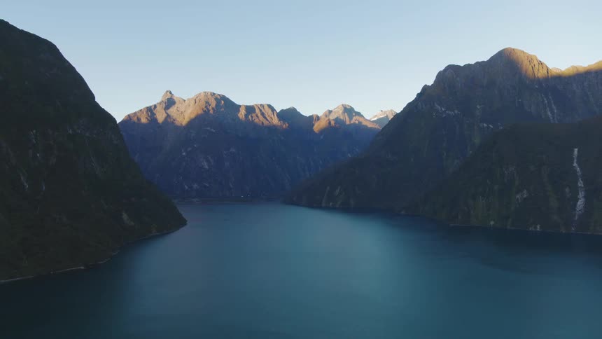 A calm lake sits between tall highlands