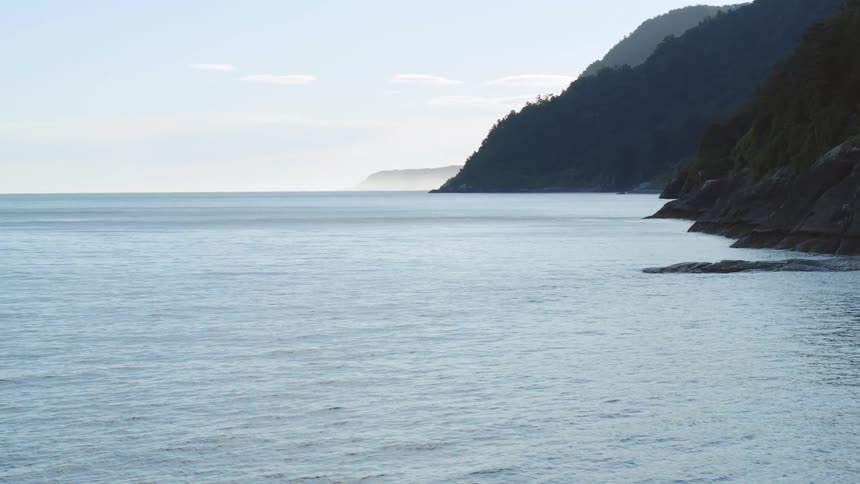 Mountains on the coast next to the ocean at morning