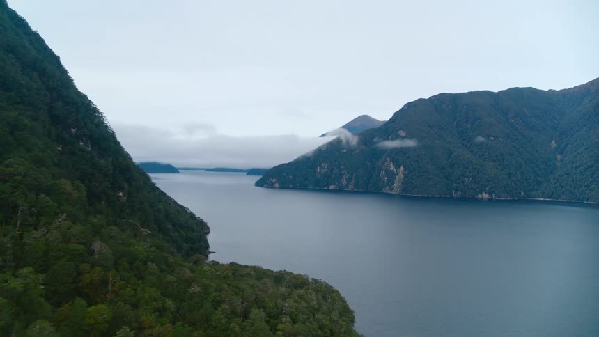 An aerial view of a lake between two mountains