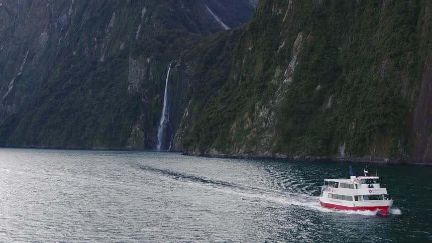 A view of a boat sailing near a waterfall