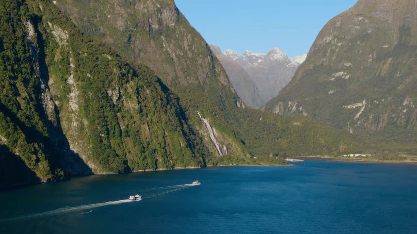 Passenger ferries driving over the calm surface of a lake in the mountains