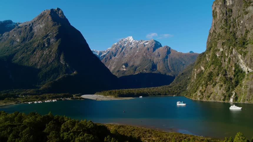 Boats floating on the calm surface of a lake in the mountains