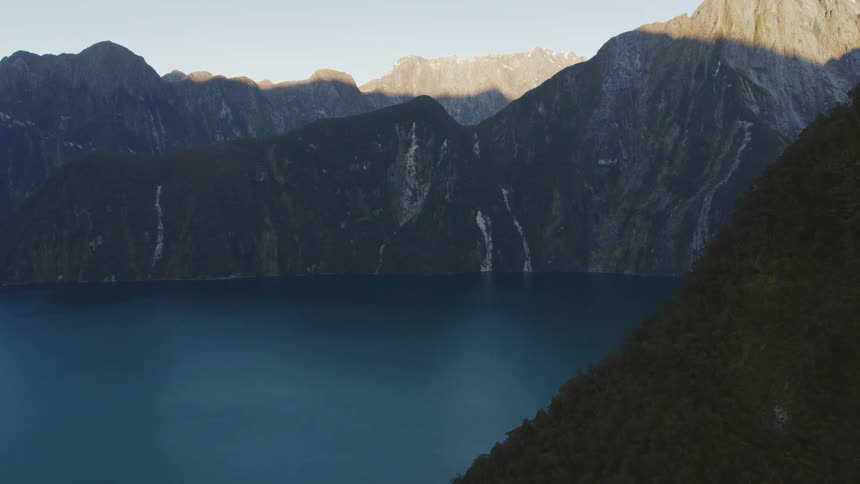 The water meets the edge of the mountain