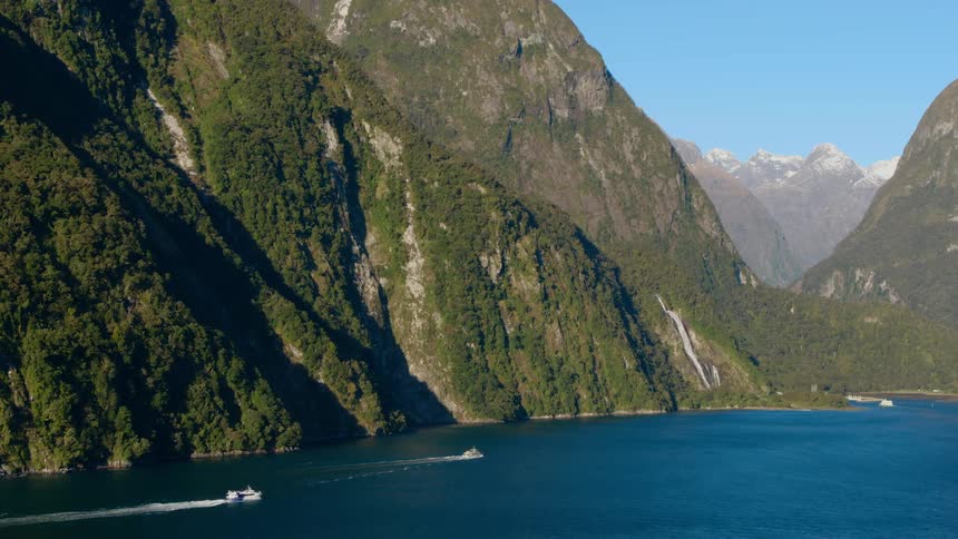 Ferries driving on the calm surface of a lake in the mountains