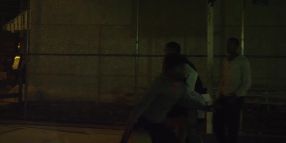 People are playing basketball at night