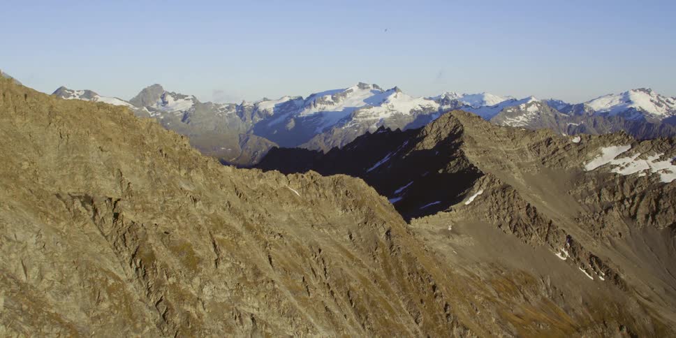 Mountain ridges and peaks dusted with snow on a sunny day
