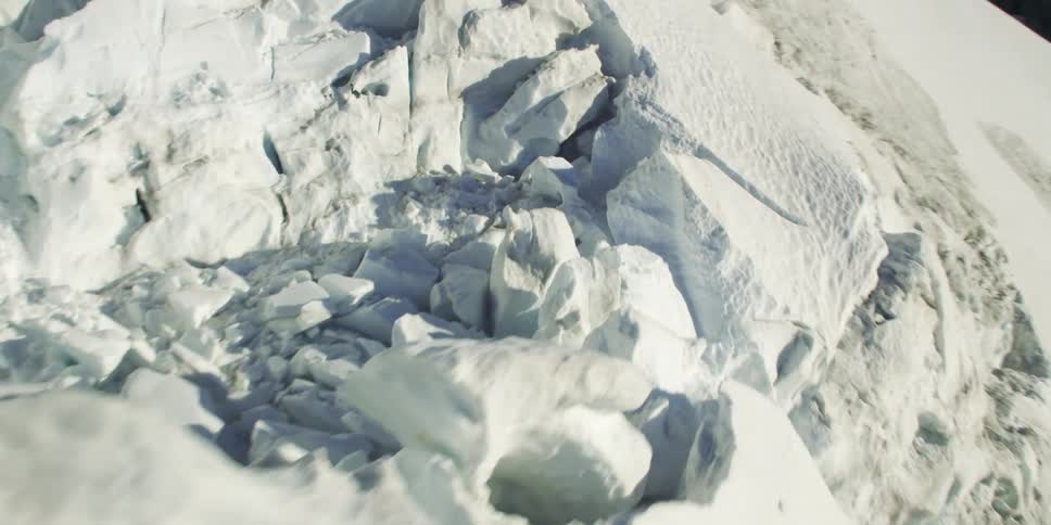 A snow covered mountain slope during the day