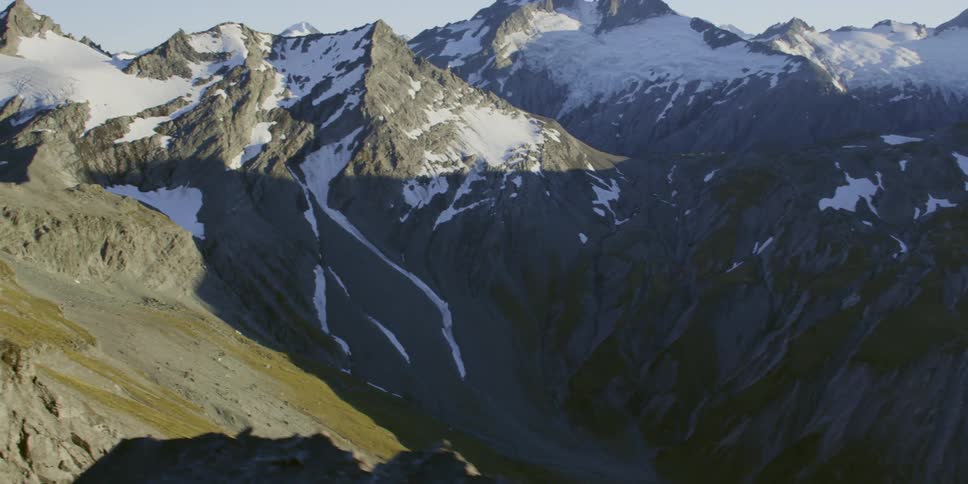 Snow lingers on summer mountains