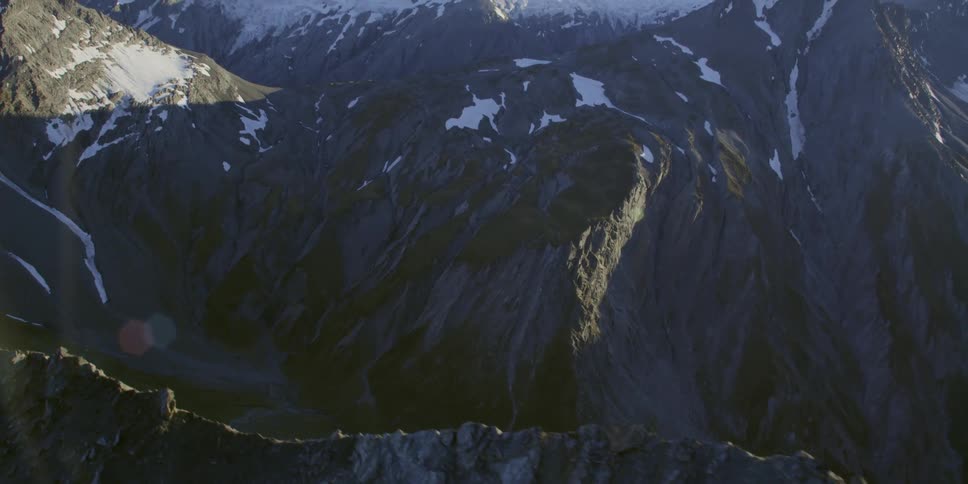 The sun shines over the tall mountains