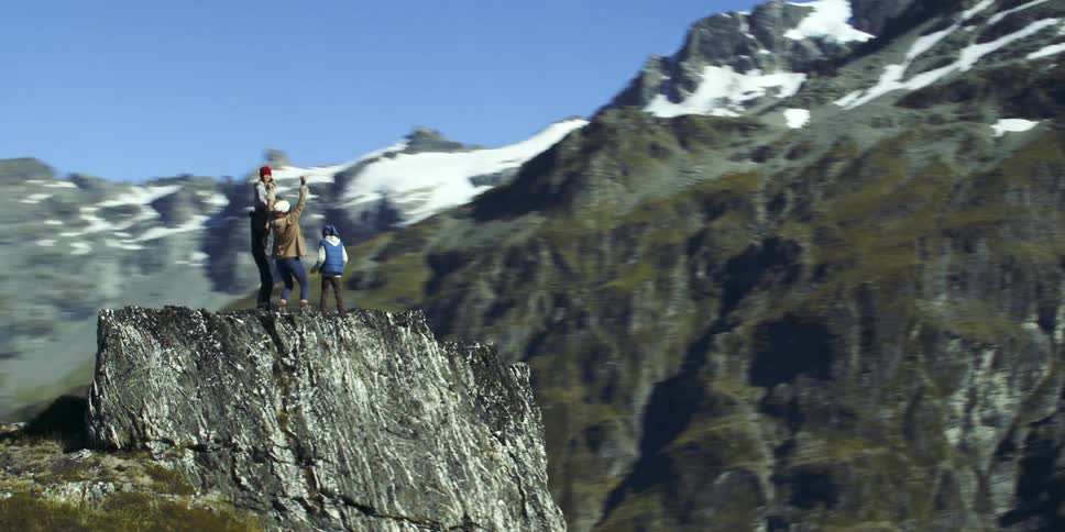 A family cheer on the top of the mountain
