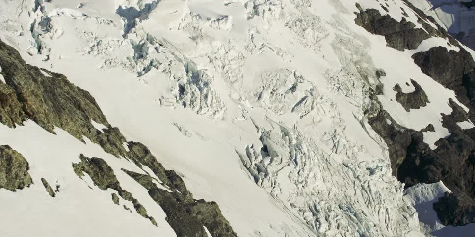 Aerial view of mountain slopes covered in snow