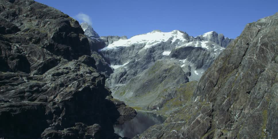 A still lake sits between tall canyons