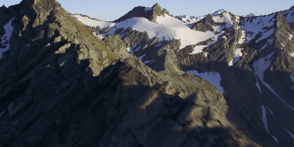 The mountains are tall and covered with snow