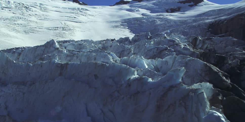 Snow and ice covered mountain ridge on a sunshiny blue sky day