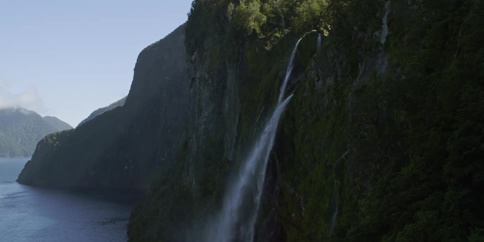 The waterfall falls over into the ocean