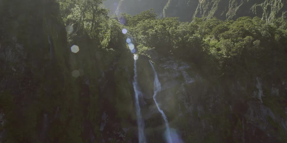 Water cascades down the side of a cliff