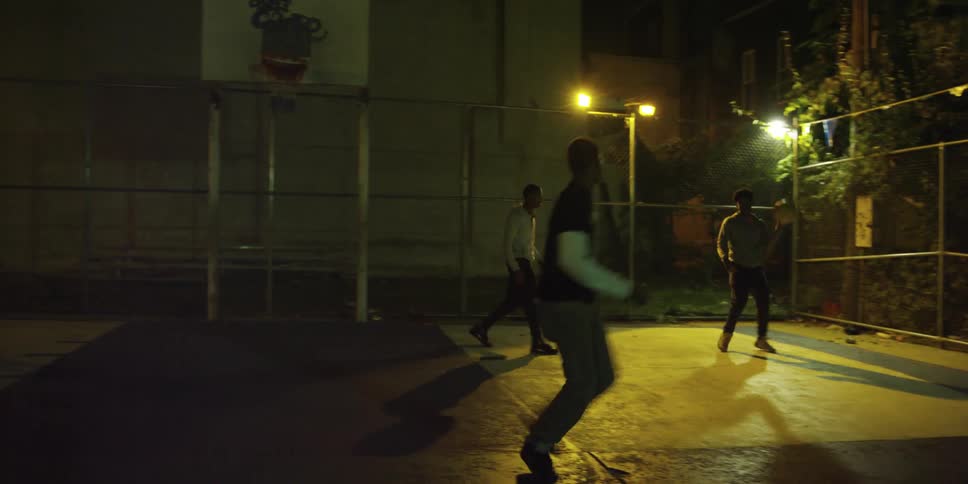 A group of men play basketball