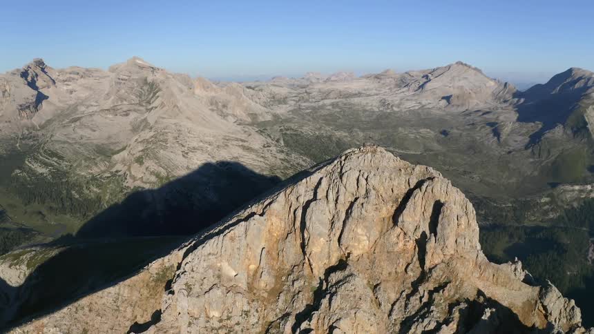A mountain casts a shadow onto a nearby mountain range